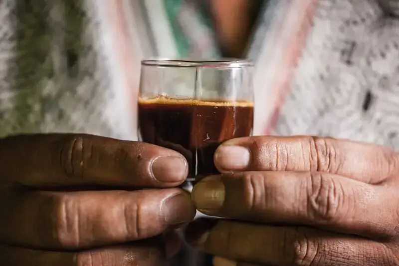 Hands holding a ceremonial cup